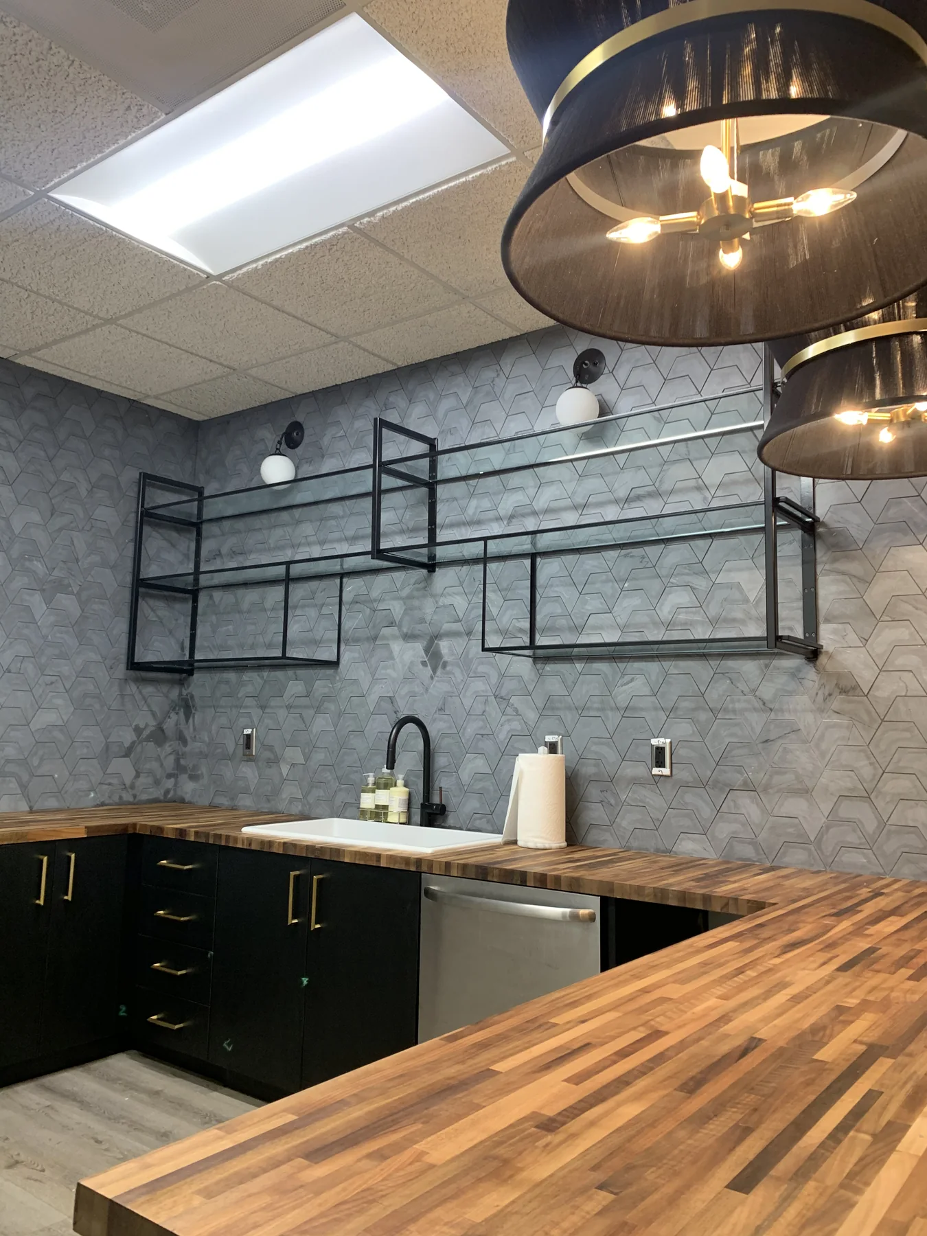 Black metal wall storage system fabricated for a commercial kitchen