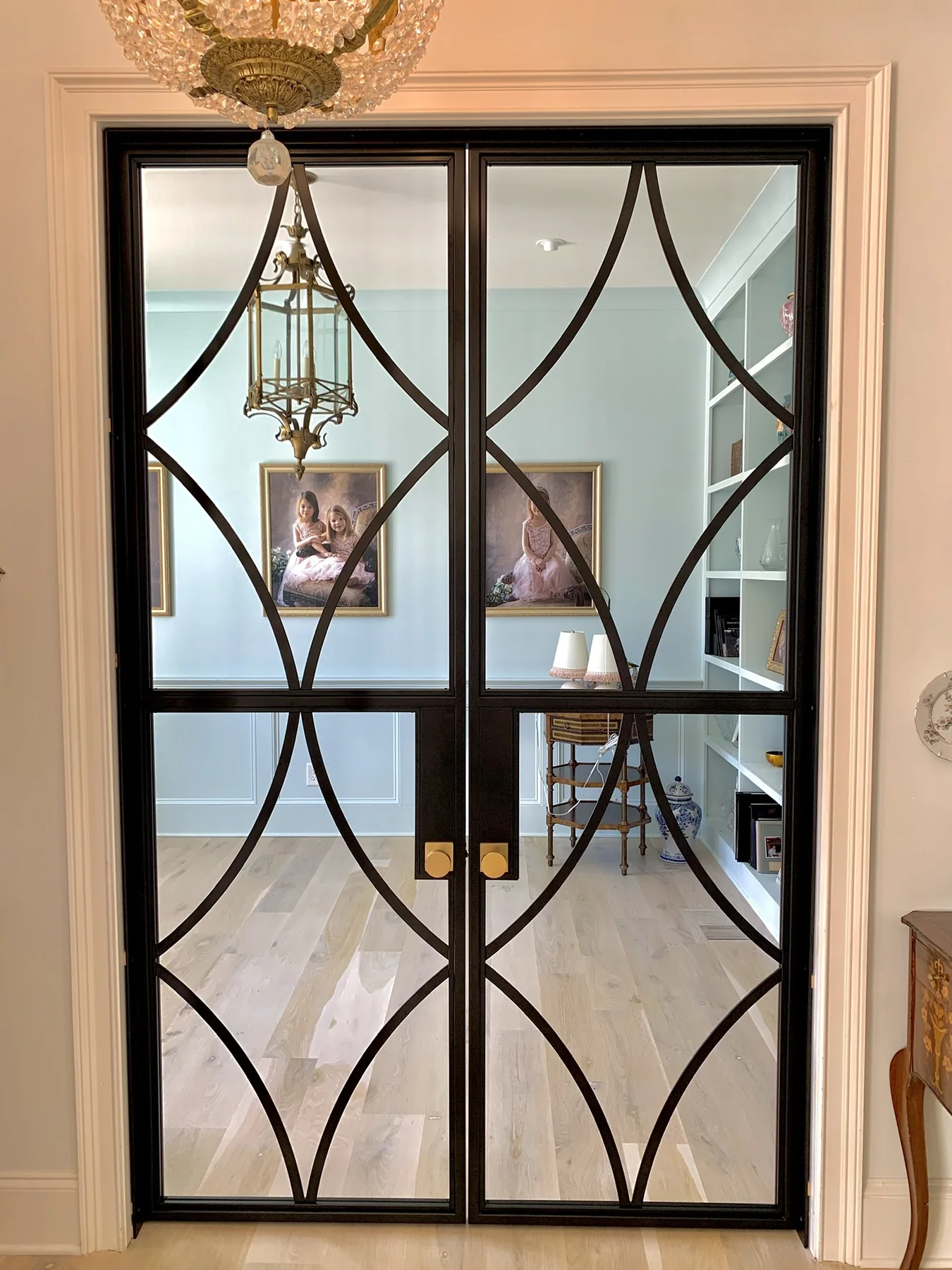 Decorative black steel double doors with curved geometric glass panels
